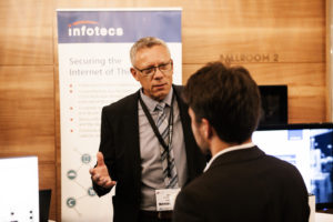 03_Security-of-Things-World-2016_Product-Manager-Joerg-Wiedecke-speaks-with-a-client-300x200 Security of Things World 2016 in Berlin: Jörg Wiedecke spricht über IoT Security
