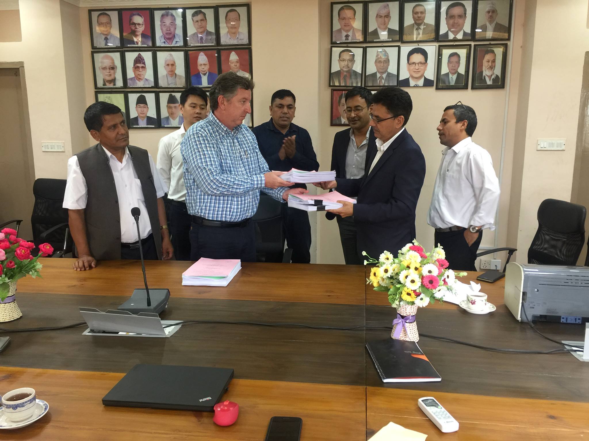 Dr. Beau Freeman of Lahmeyer signs the contract documents with Madhav Belbase, Joint Secretary of the WECS